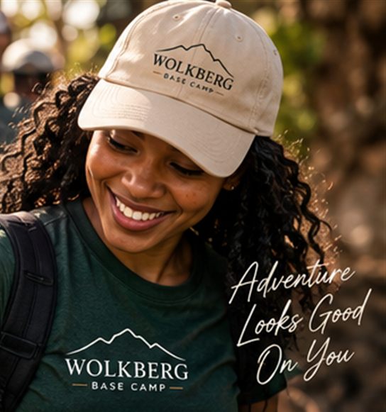 Smiling guest in a Wolkberg Base Camp cap